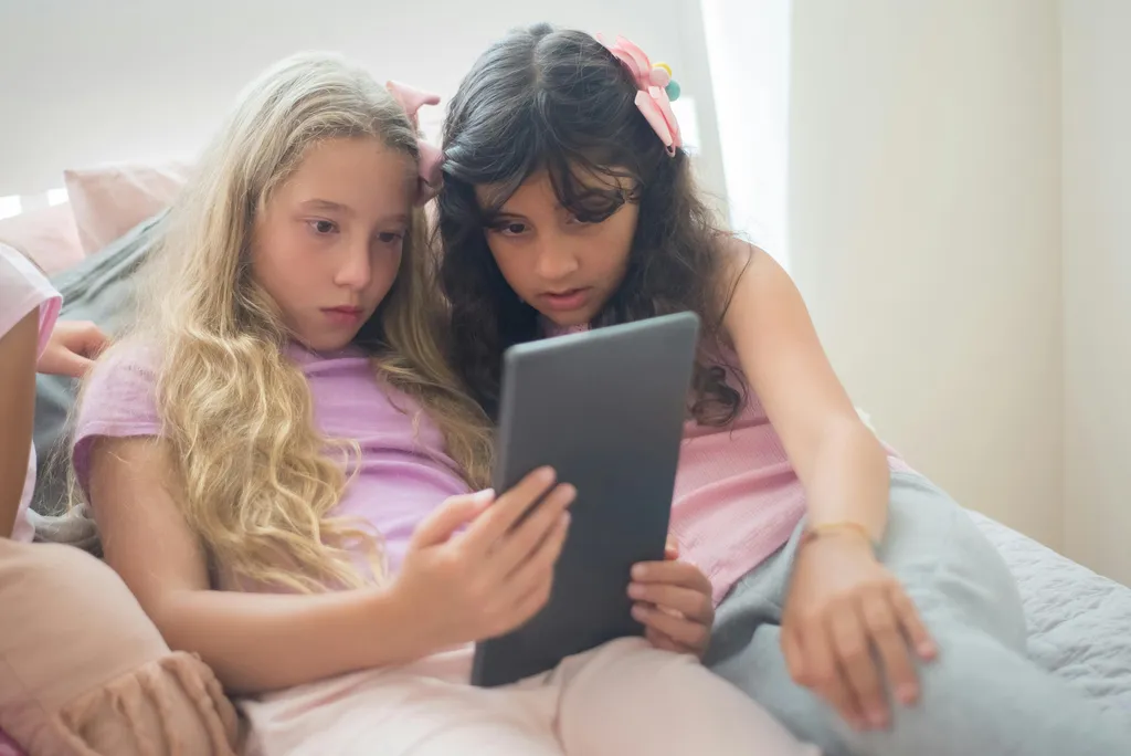 A child using a tablet while parents think about safer video choices