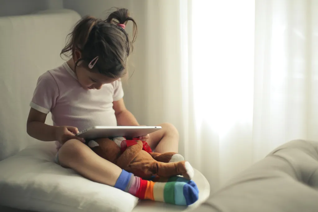 A parent and child looking at a tablet together