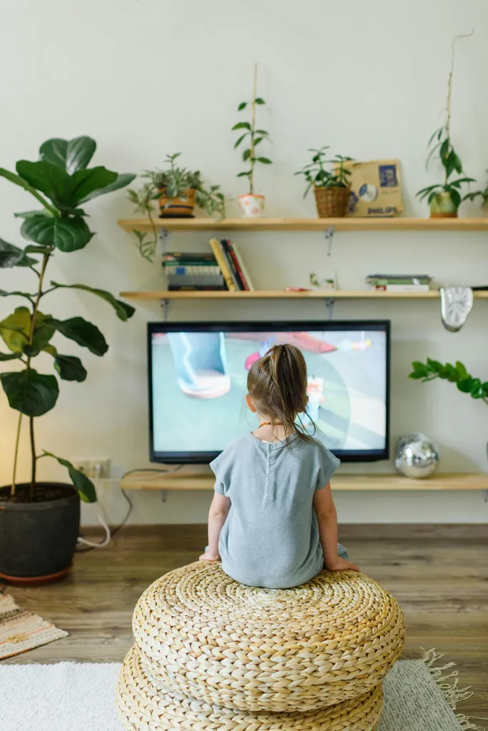 A child looking thoughtfully at a tablet