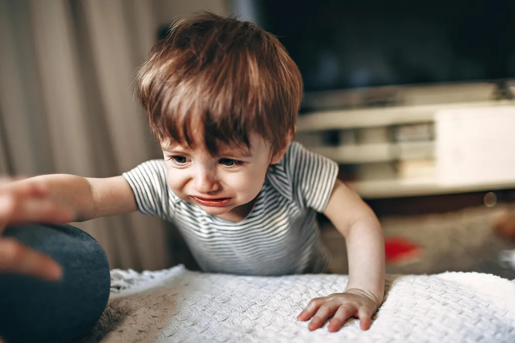 A child looking closely at a tablet